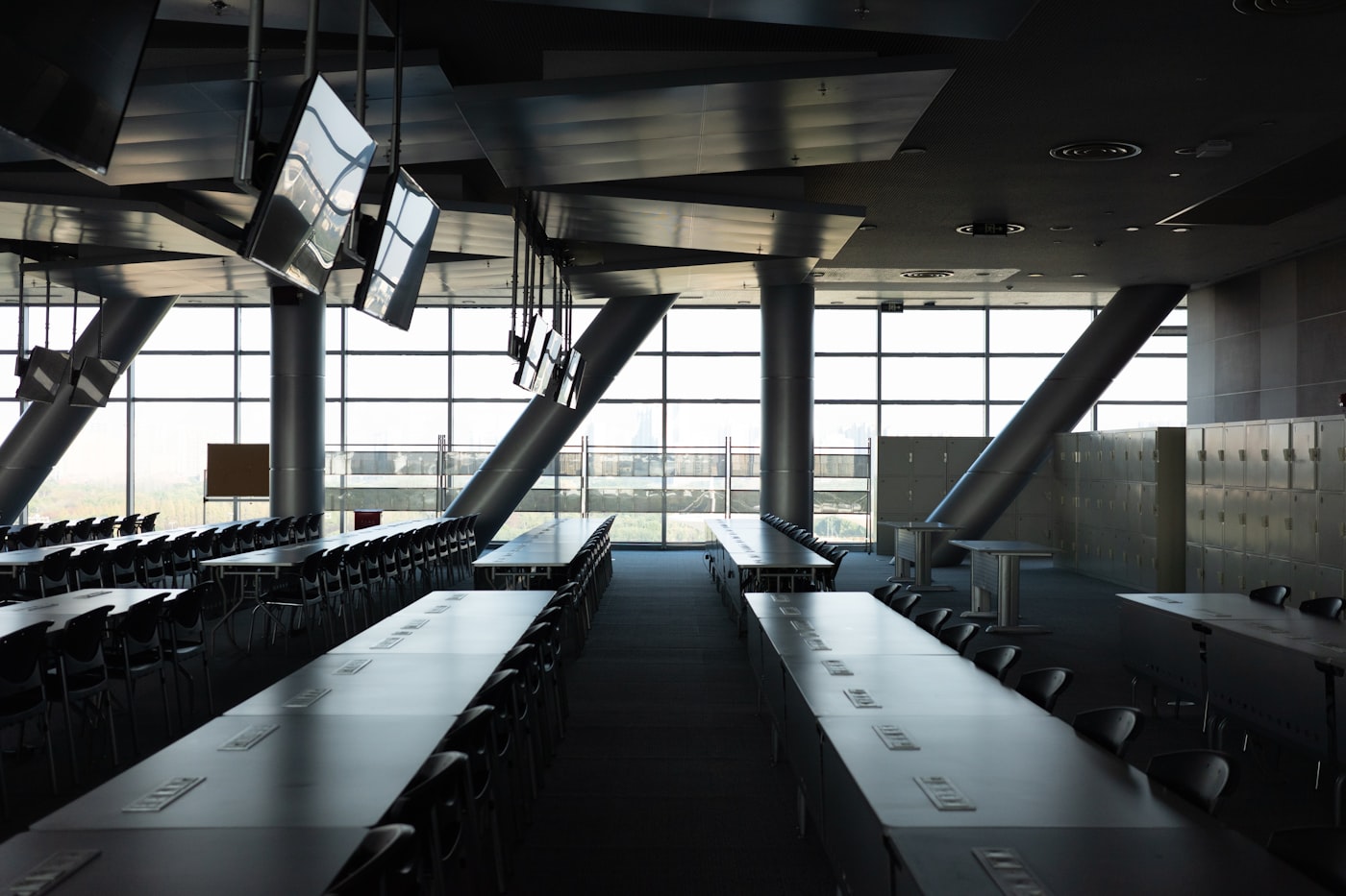 Long meeting-room table with chairs and floor-to-ceiling windows