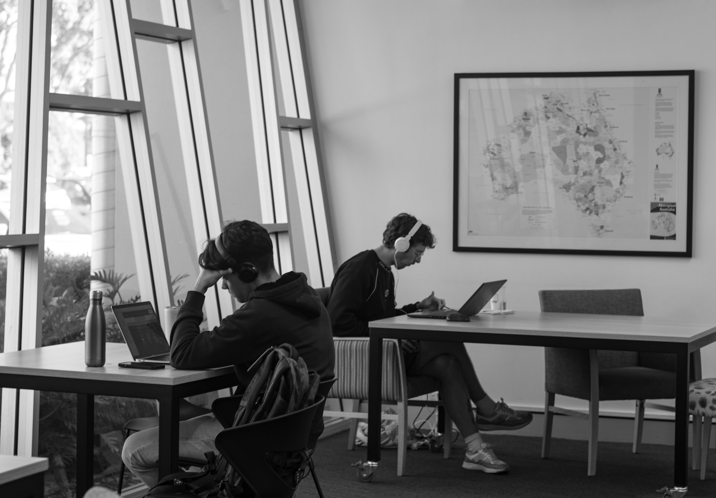 Two students working quietly in a sunlit study space